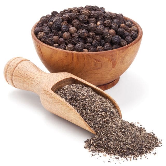 a bowl of whole black pepper along with the sppoonful of crushed black pepper