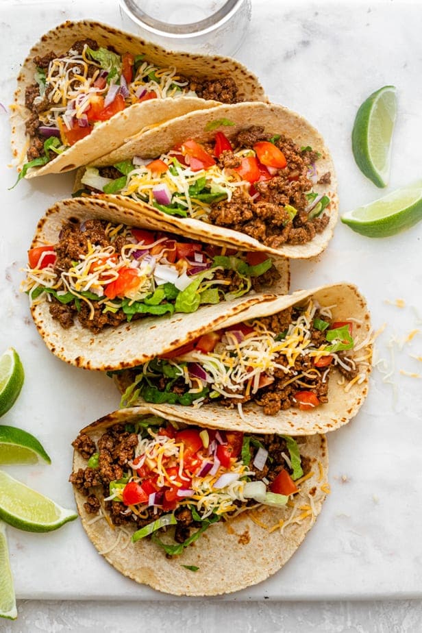 beef tacos with black pepper sauce and served with fresh veggies and cheese on top