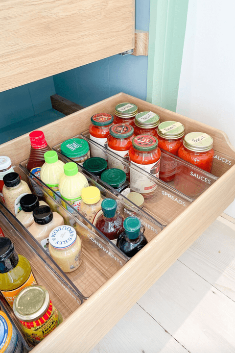 canned food organized in the drawer of the kitchen cabinet