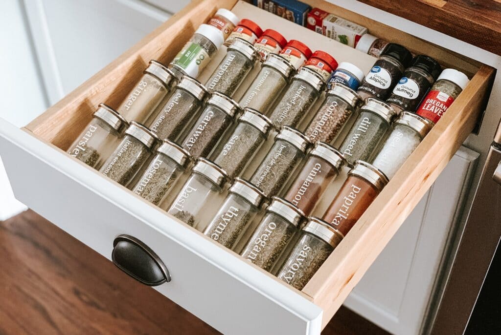 spice jars organized in drawwer of the kitchen cabinet