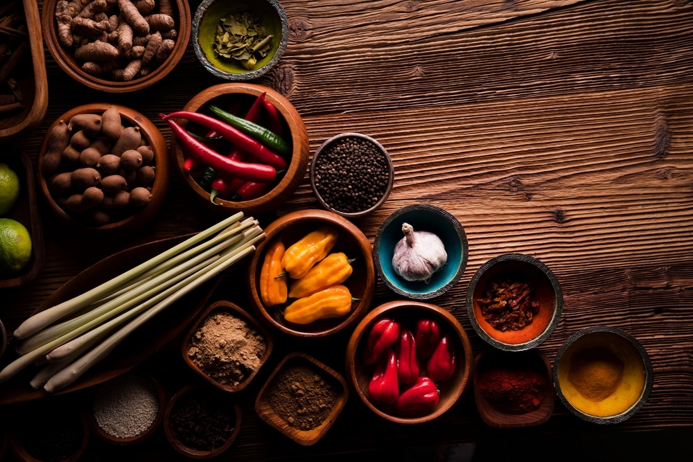 Composition Of Colorful Thai Spices In Small Teak Bowls Top View 