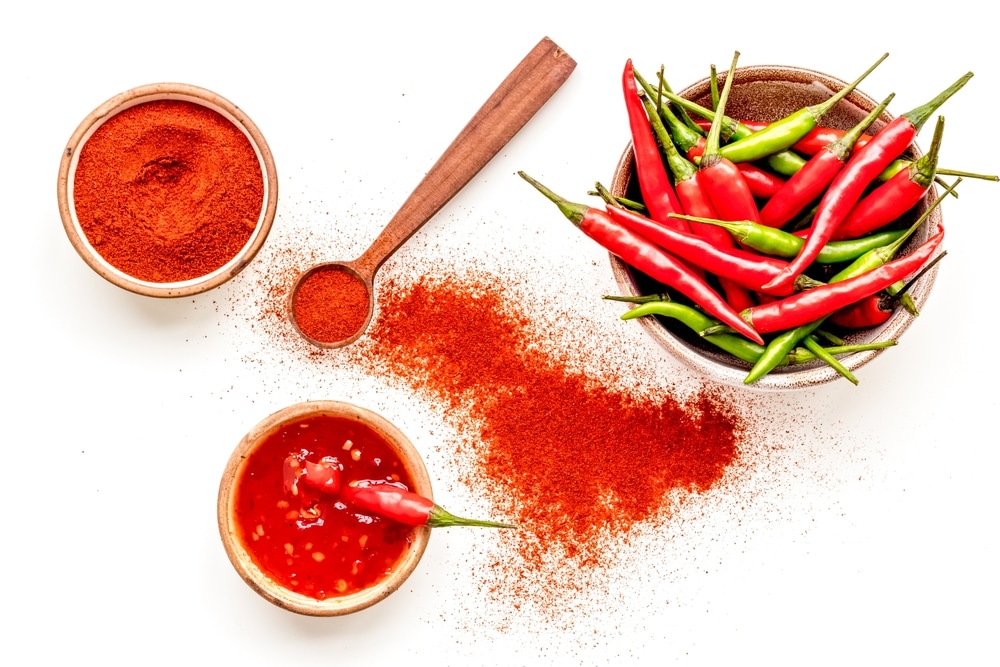 chilli pepper on white table background top view