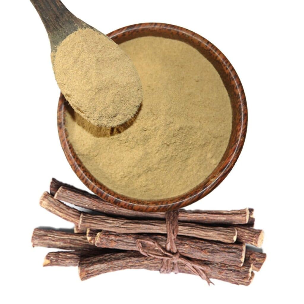 a bowl of powdered licorice along with whole dried licorice