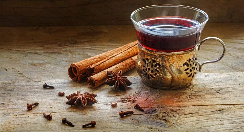 clove tea along with whole cloves and cinnamon sticks 