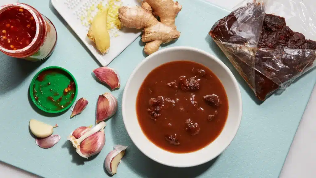 making of tamarind sauce along with ingredients on a slab