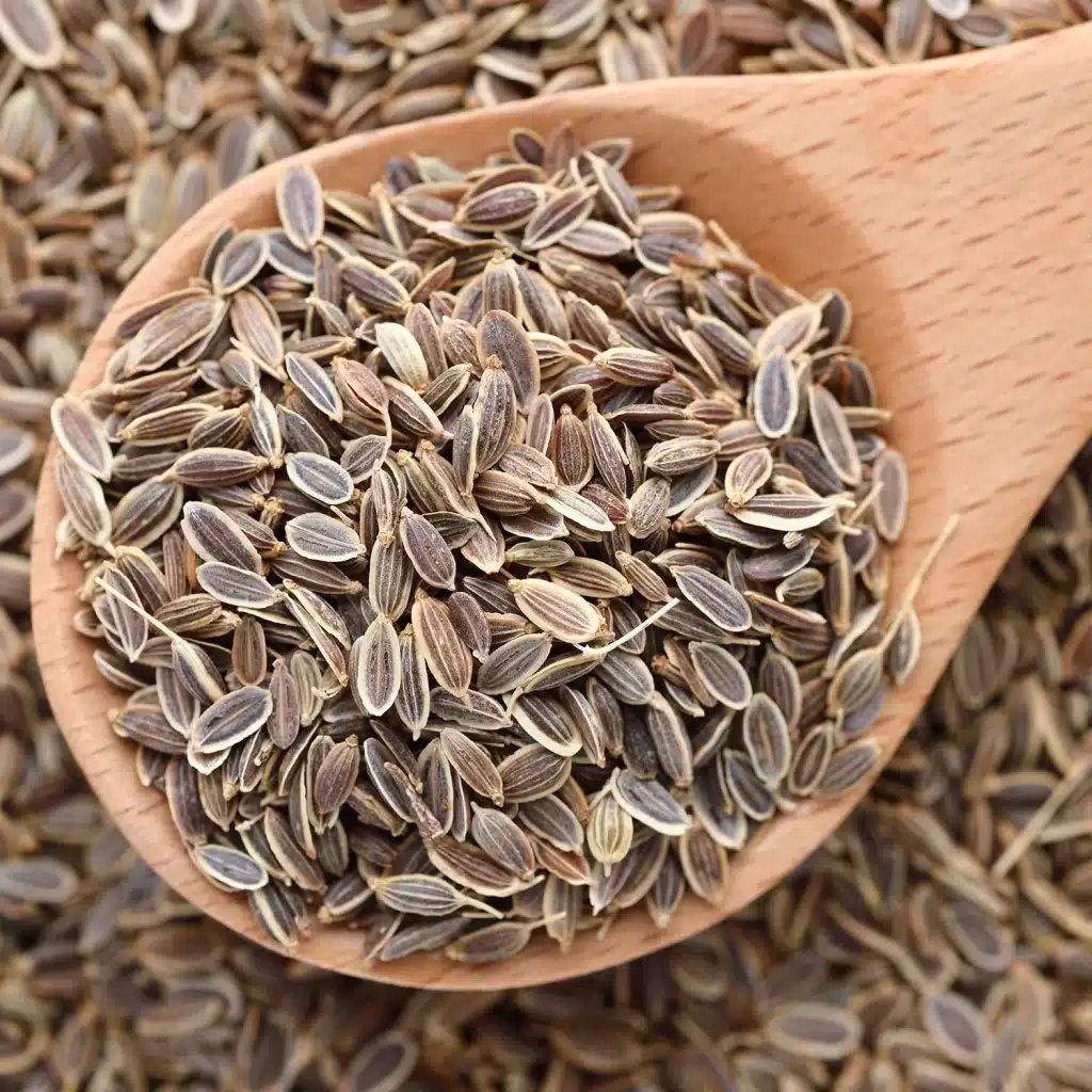 whole dill seeds in a wooden spoon