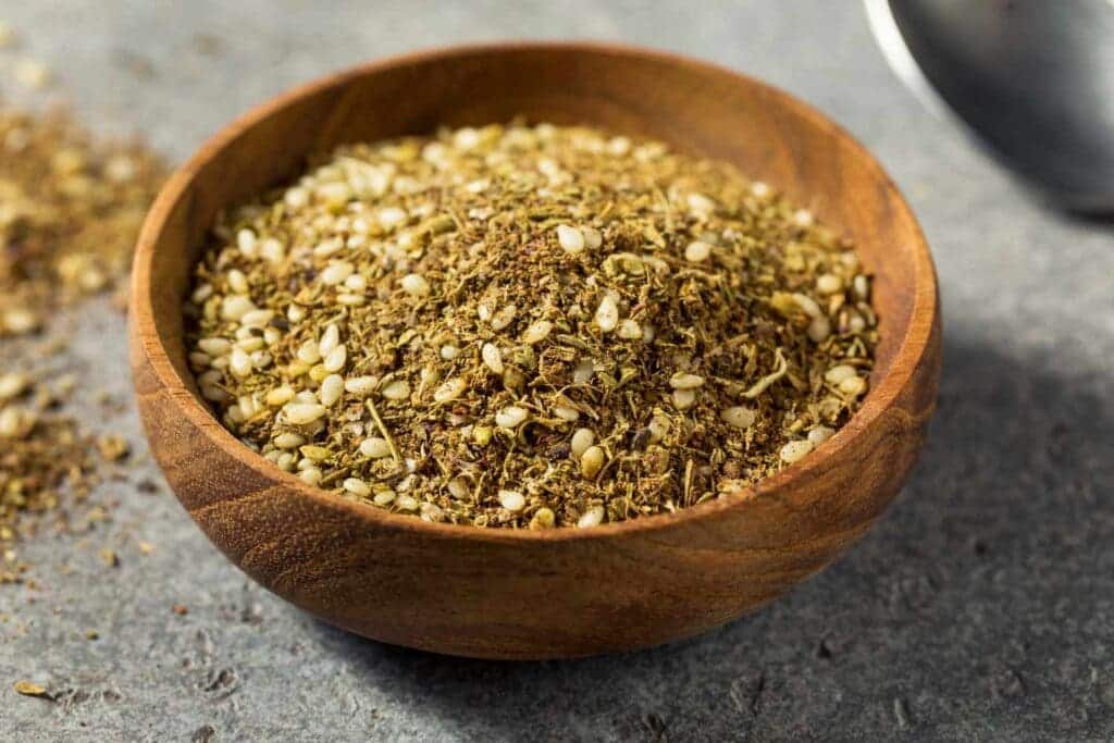 zataar spice mix in a wooden bowl placed on a surface