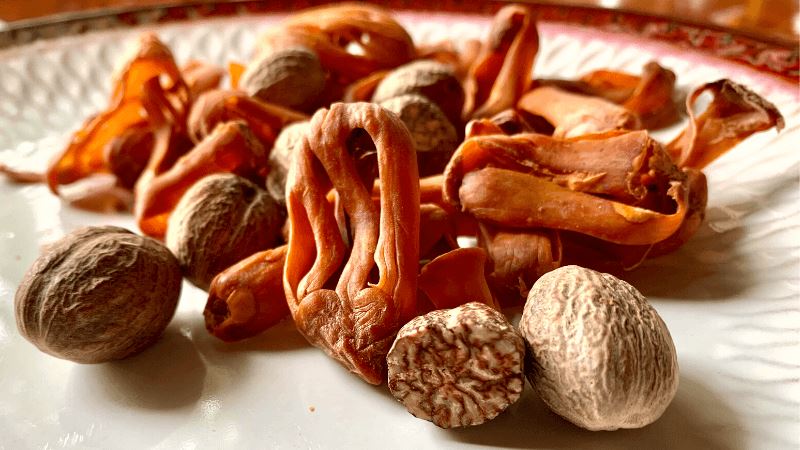 whole nutmeg and mace in a plate