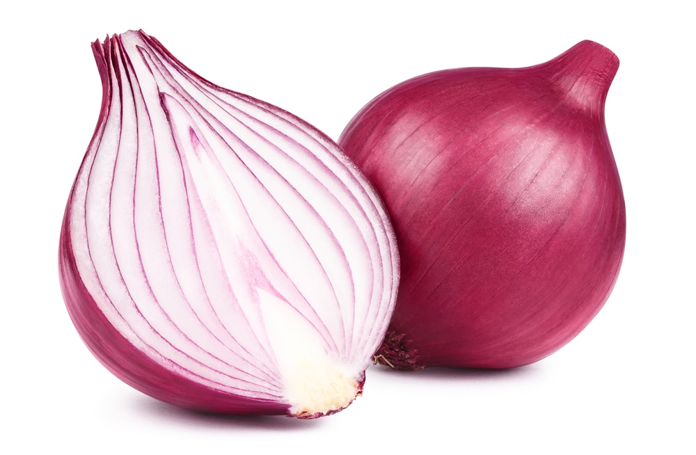 Red whole and sliced onion isolated on white background