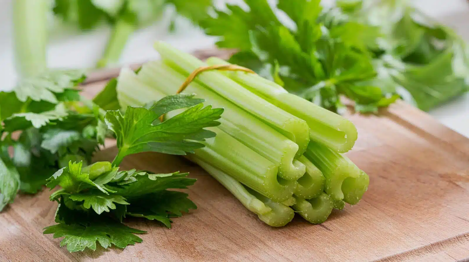 Celery Stems And Leaves On Wooden Cutting Board