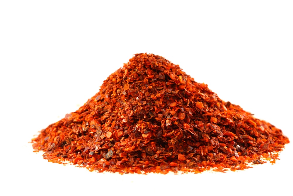 heap of Aleppo Flakes red chilies pepper soft focus isolated