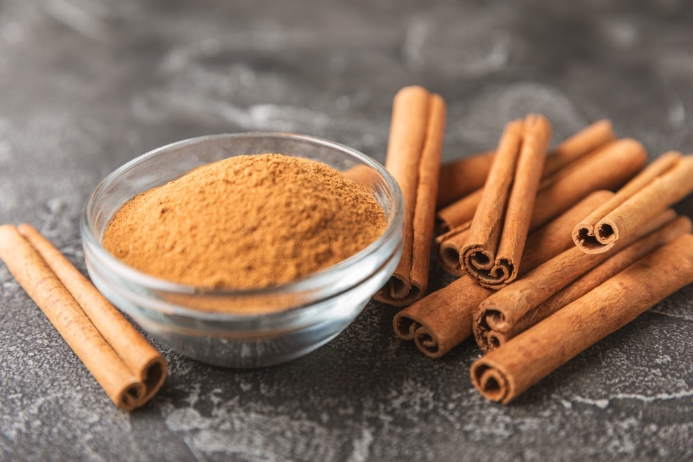 Cinnamon Sticks On A Textured Wooden Background 