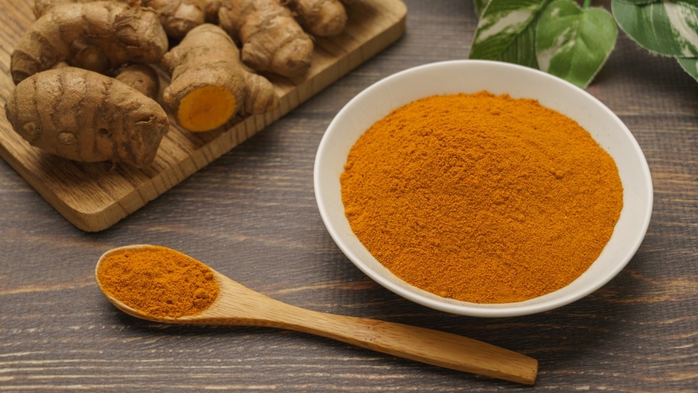 Turmeric And Turmeric Powder On Wood Grain Background