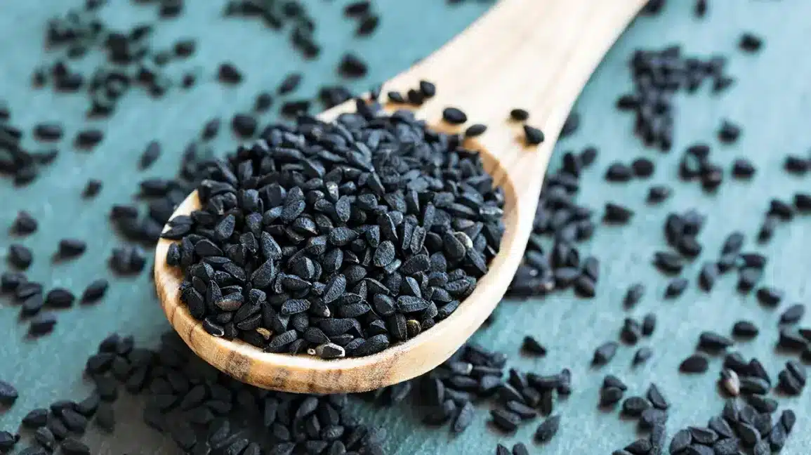 nigella seeds in a wooden spoon