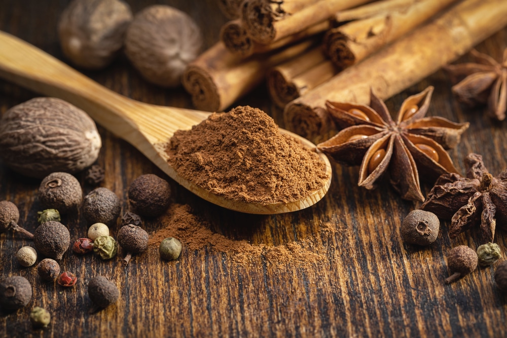 A Set Of Spices On A Brown Table Wooden Spoon